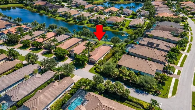 an aerial view of residential houses with outdoor space and lake view