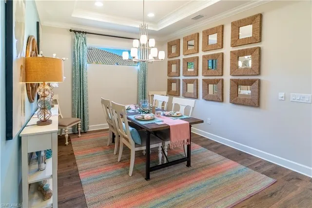 a dining room with furniture and wooden floor