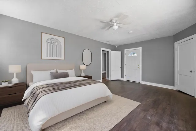 a bedroom with a large bed and chandelier