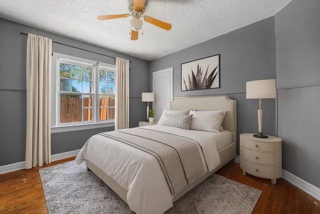 a bedroom with a bed and a painting on the wall