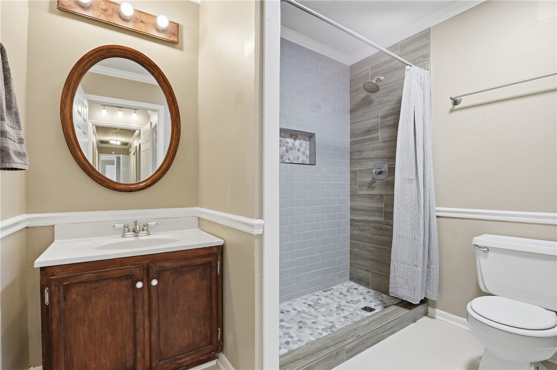 4304 Old Buncombe Road Greenville, SC 29617 - Photo 21 of 49 This bathroom features a sleek shower and a practical vanity, optimizing both comfort and utility.