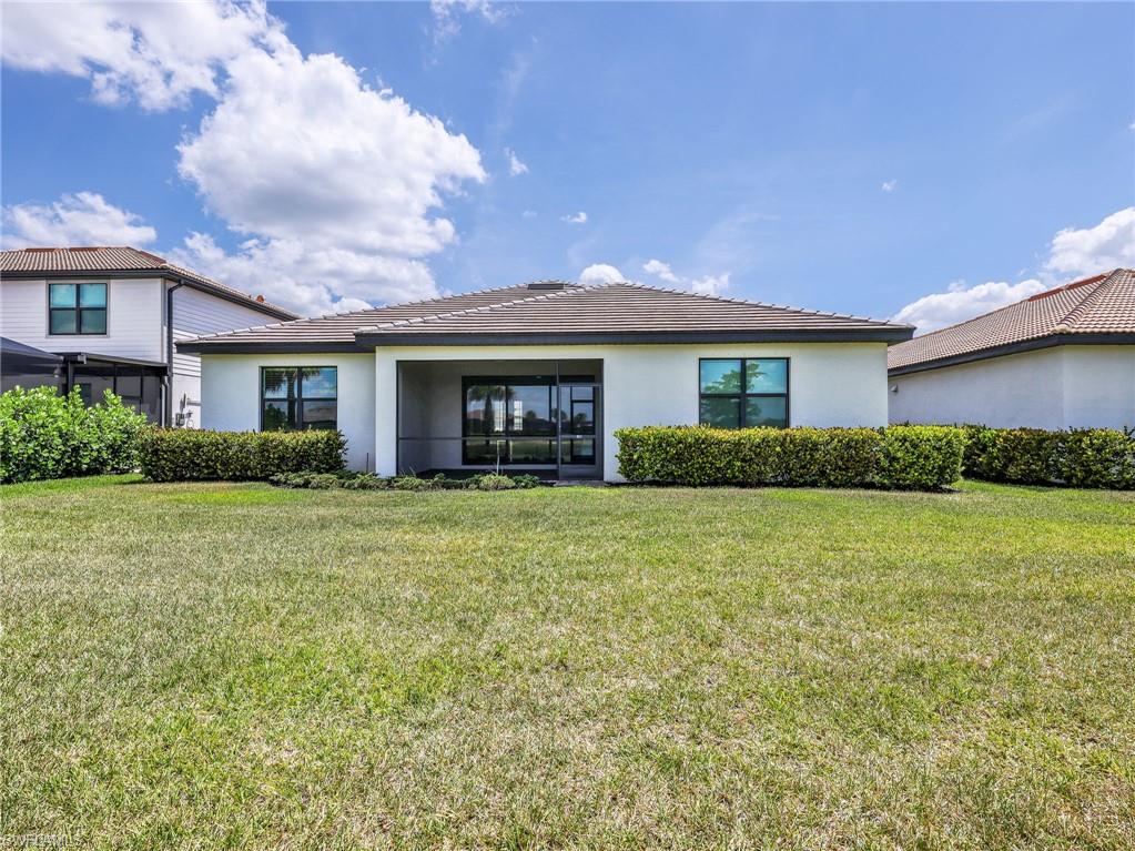 18278 Ridgeline Drive Estero, FL 33928 - Photo 30 of 45 a front view of a house with a garden
