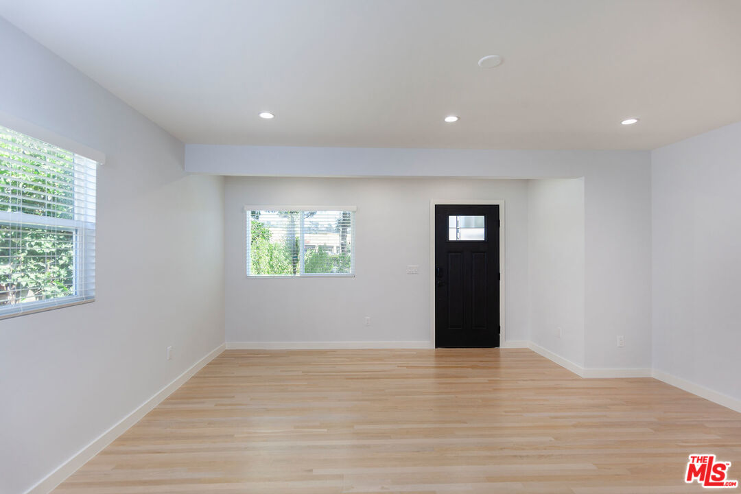 10845 Jefferson Boulevard Culver City, CA 90230 - Photo 11 of 48 a view of an empty room with wooden floor and a window