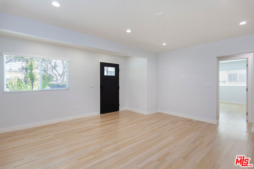 10845 Jefferson Boulevard Culver City, CA 90230 - Photo 13 of 48 a view of an empty room with wooden floor and a window