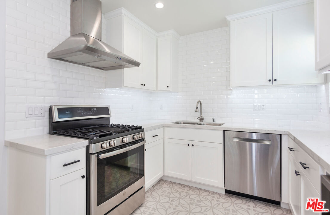 10845 Jefferson Boulevard Culver City, CA 90230 - Photo 16 of 48 a kitchen with white cabinets and appliances