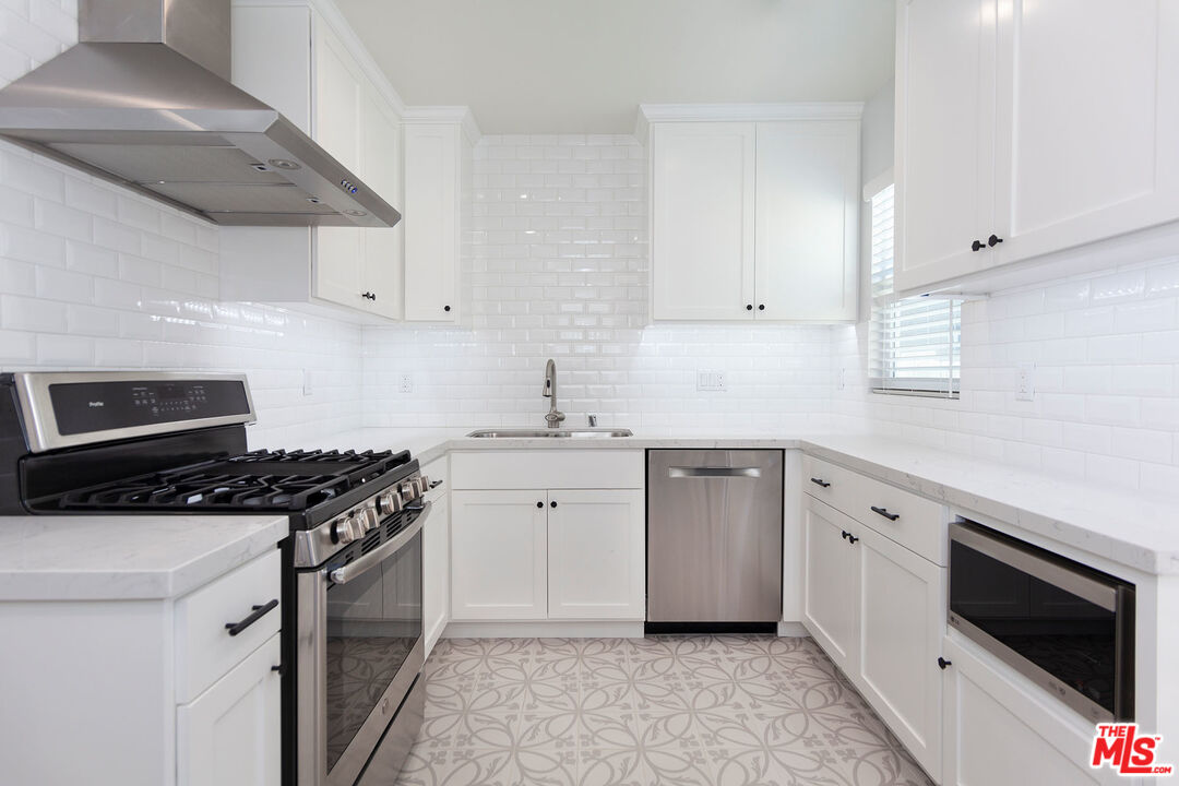 10845 Jefferson Boulevard Culver City, CA 90230 - Photo 17 of 48 a kitchen with cabinets appliances a sink and a counter top