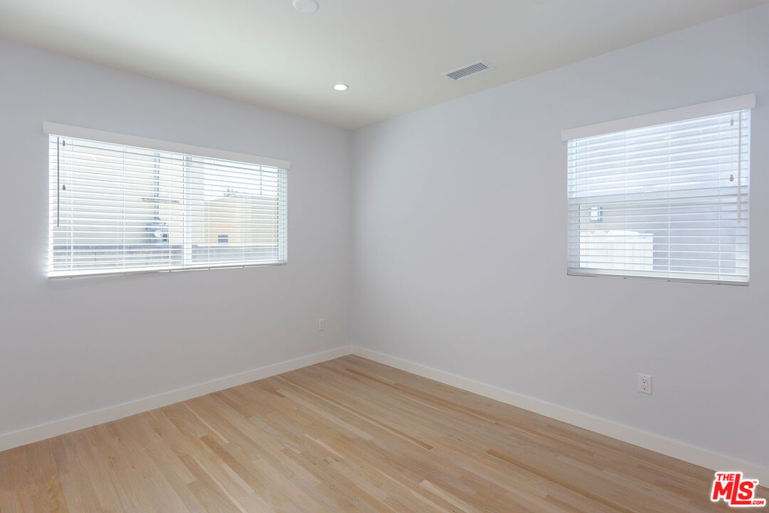 10845 Jefferson Boulevard Culver City, CA 90230 - Photo 23 of 48 a view of an empty room with wooden floor and a window