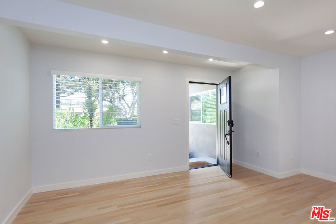 10845 Jefferson Boulevard Culver City, CA 90230 - Photo 9 of 48 an empty room with wooden floor and windows