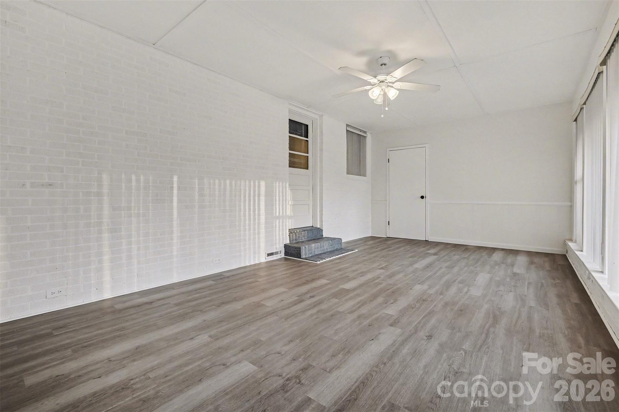 1343 Cedar Pines Lake Road Lancaster, SC 29720 - Photo 14 of 25 wooden floor in an empty room with a window