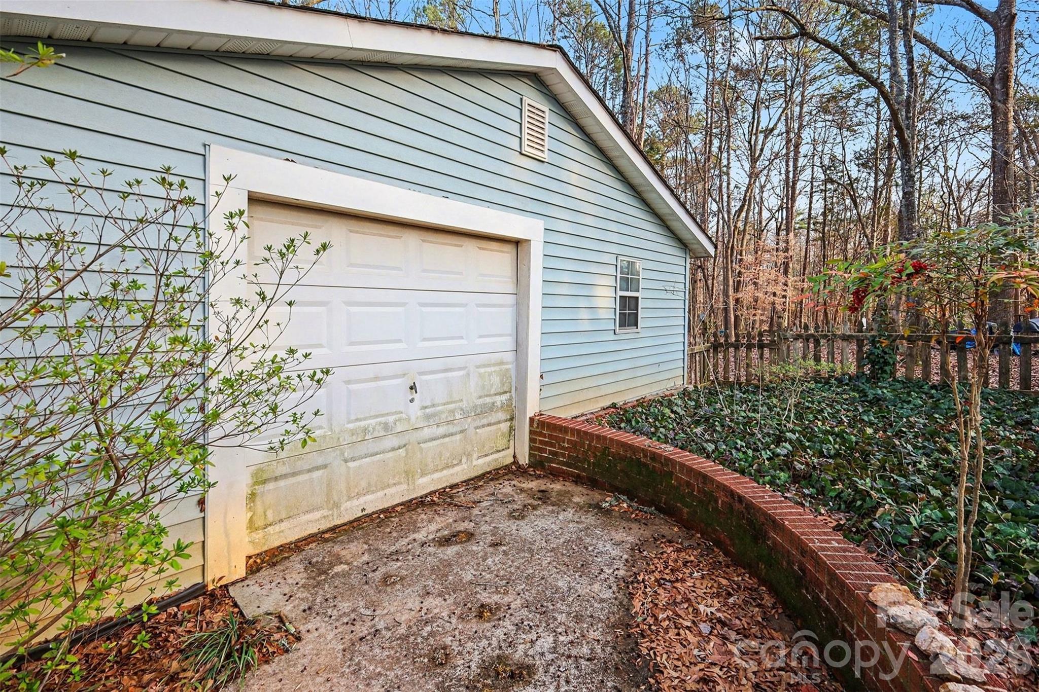 1343 Cedar Pines Lake Road Lancaster, SC 29720 - Photo 20 of 25 a view of a backyard with plants and large trees