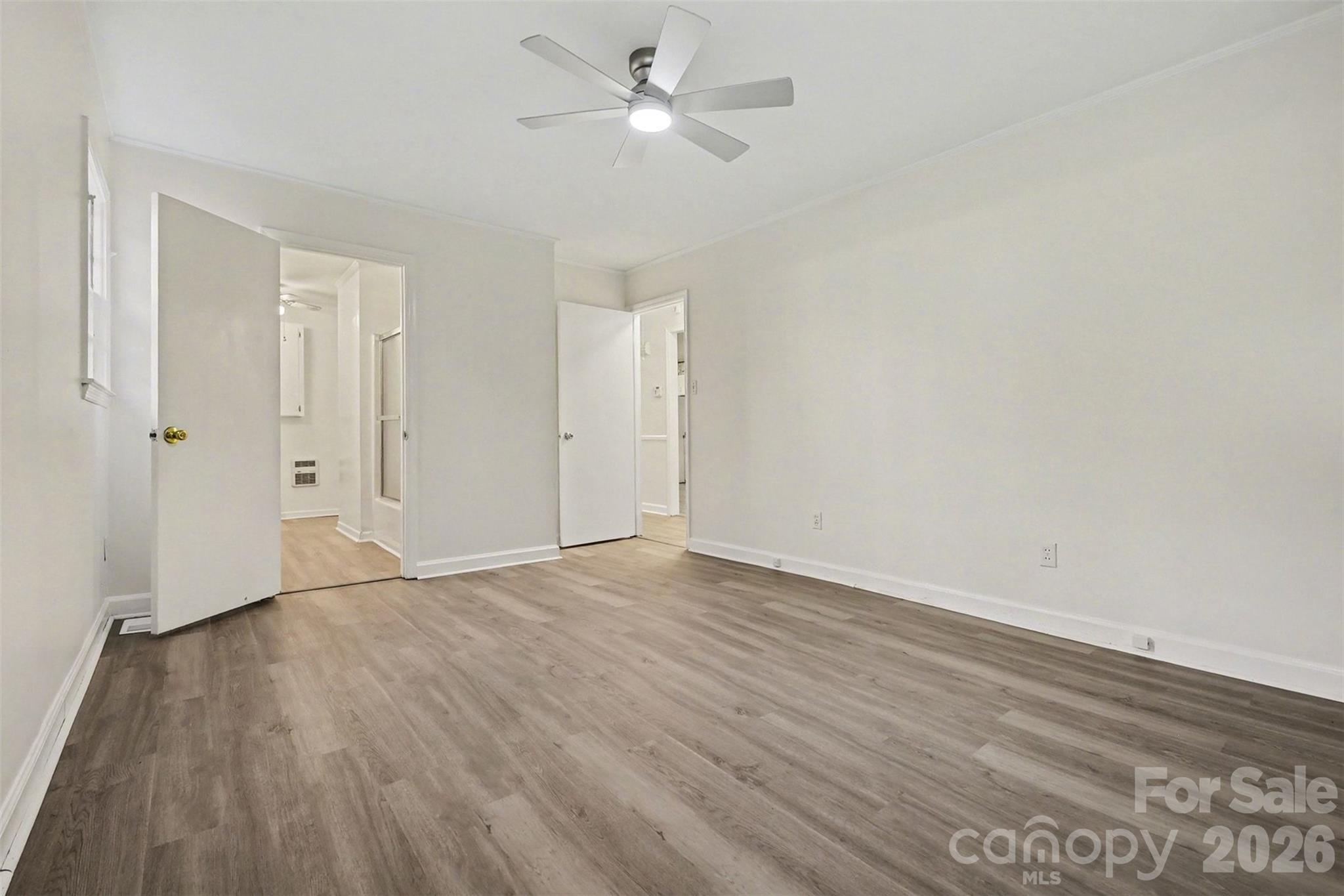 1343 Cedar Pines Lake Road Lancaster, SC 29720 - Photo 9 of 25 an empty room with wooden floor and windows