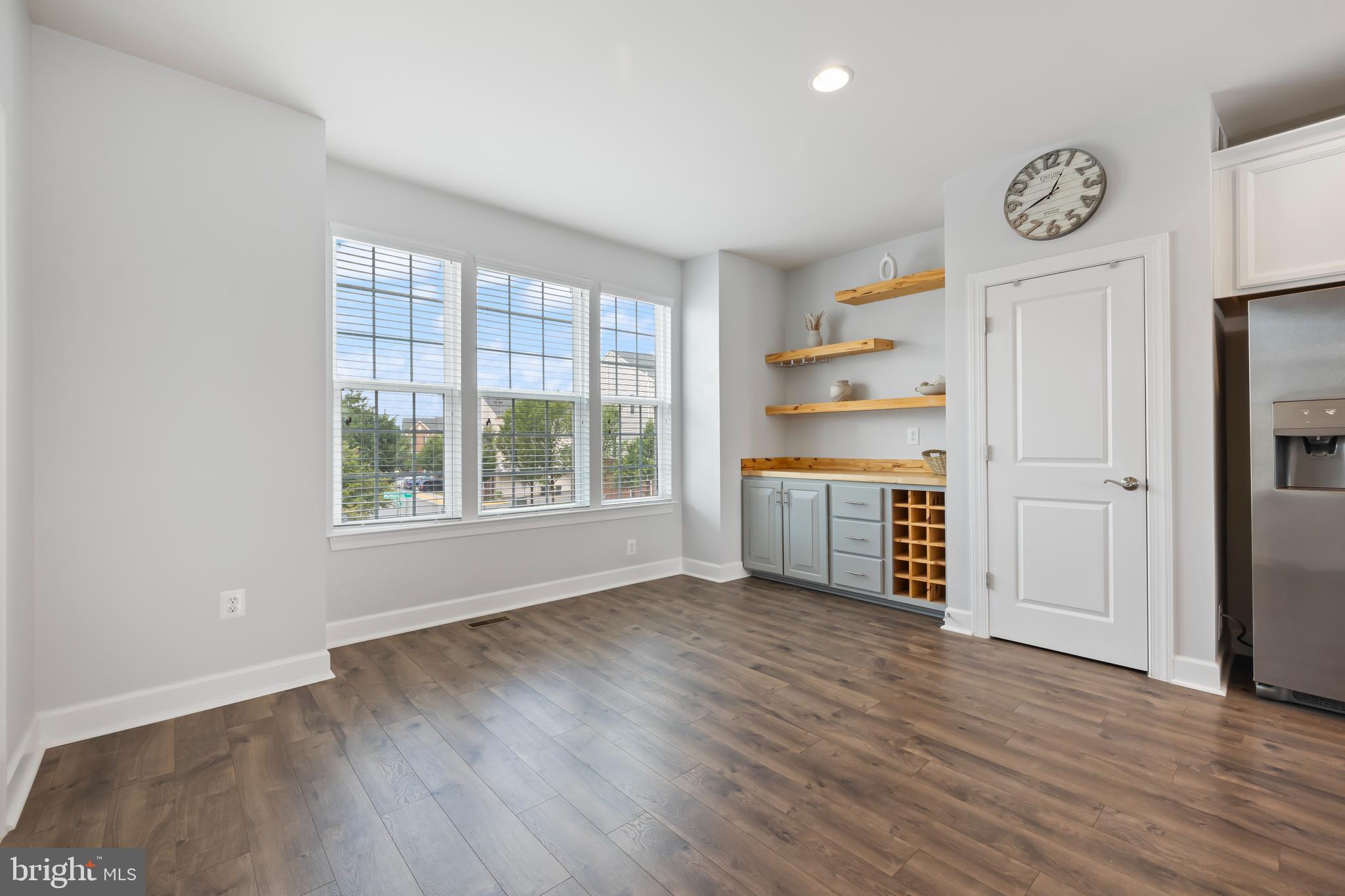 7071 Mongoose Trail Gainesville, VA 20155 - Photo 13 of 51 a view of a kitchen with fridge and wooden floor