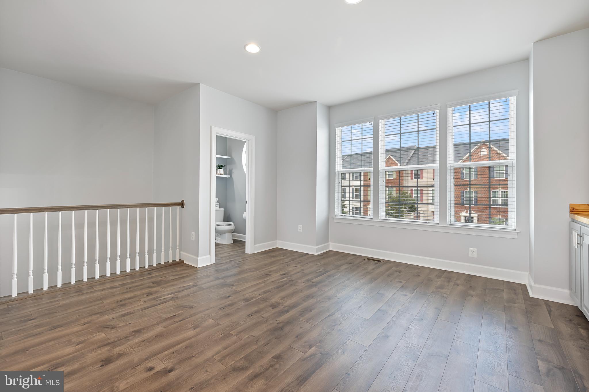 7071 Mongoose Trail Gainesville, VA 20155 - Photo 15 of 51 wooden floor in an empty room with a window