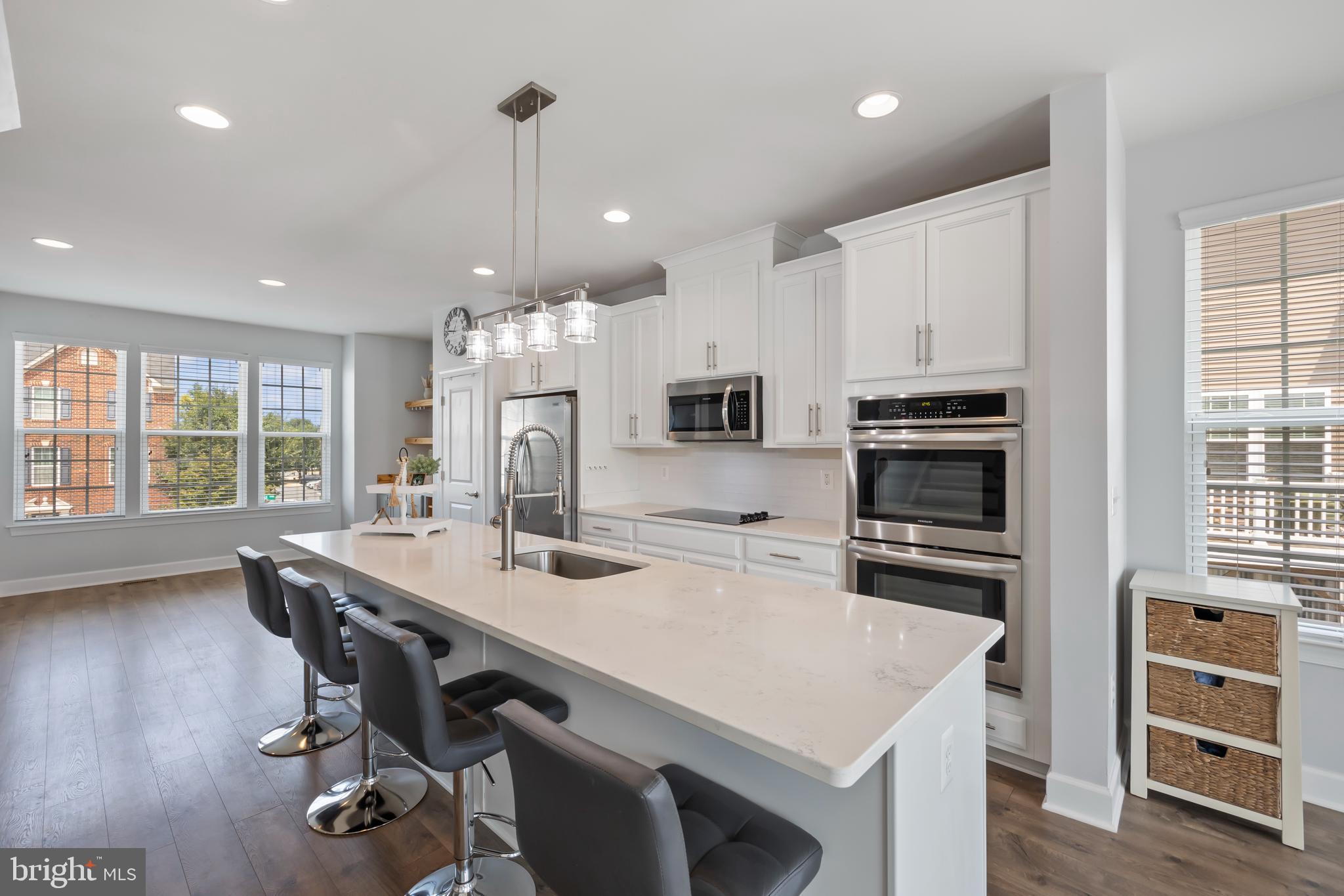 7071 Mongoose Trail Gainesville, VA 20155 - Photo 19 of 51 a kitchen with stainless steel appliances a stove a sink a microwave a refrigerator and cabinets