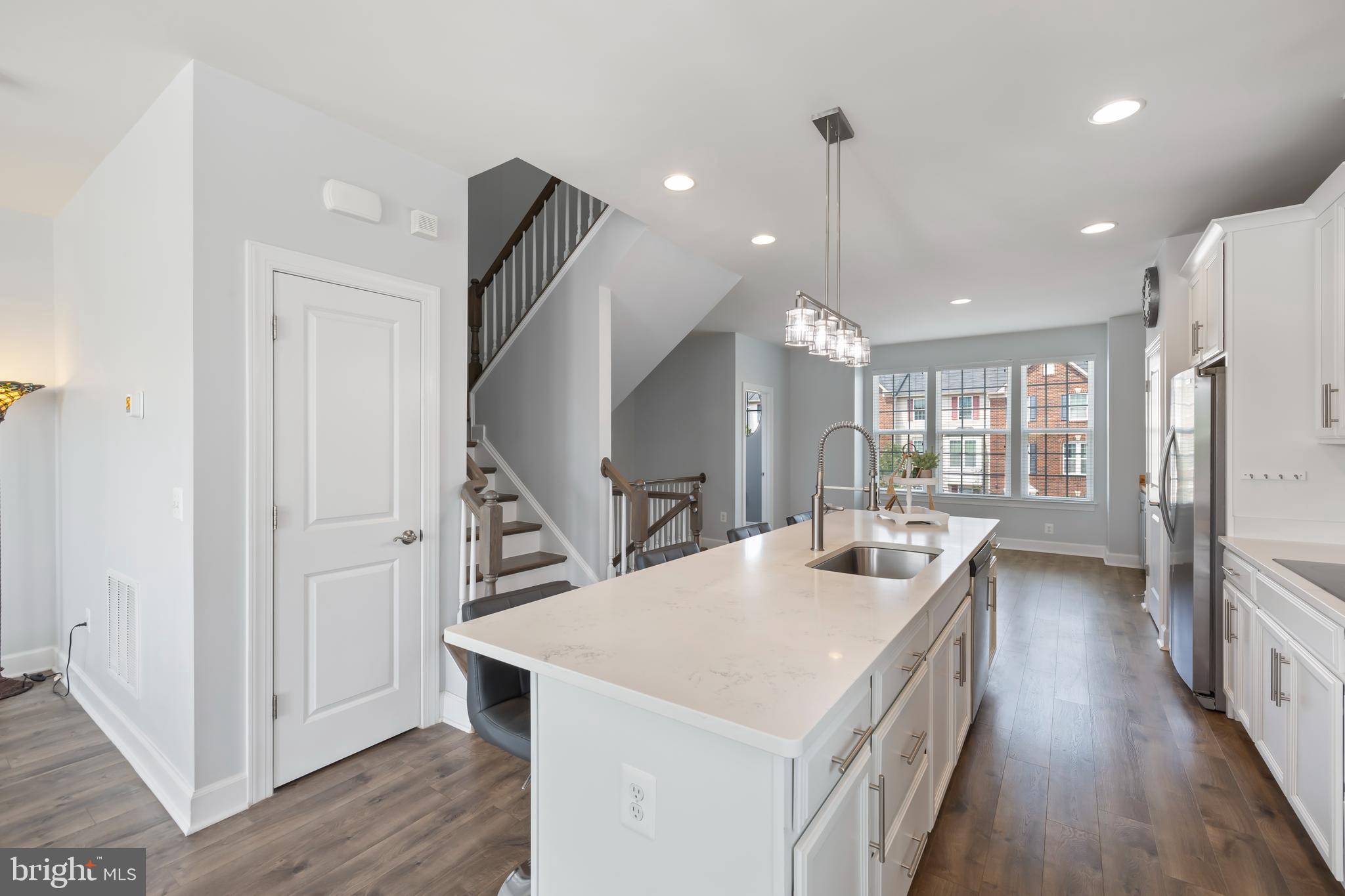 7071 Mongoose Trail Gainesville, VA 20155 - Photo 20 of 51 a kitchen with counter top space a sink a refrigerator and a view of living room