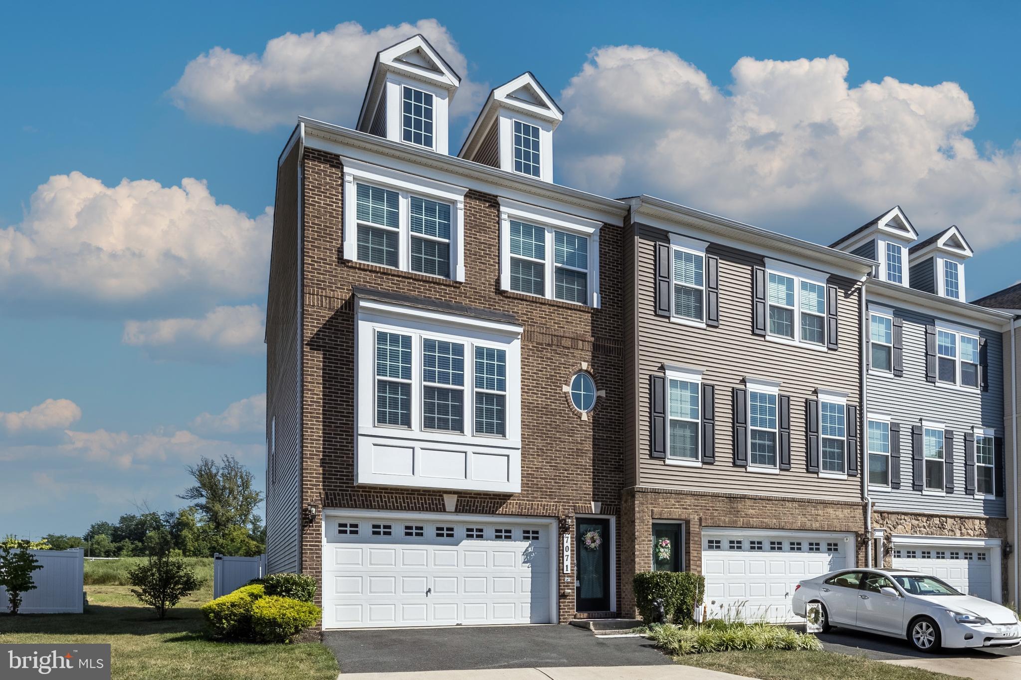 7071 Mongoose Trail Gainesville, VA 20155 - Photo 2 of 51 a front view of a building with lot of cars and trees
