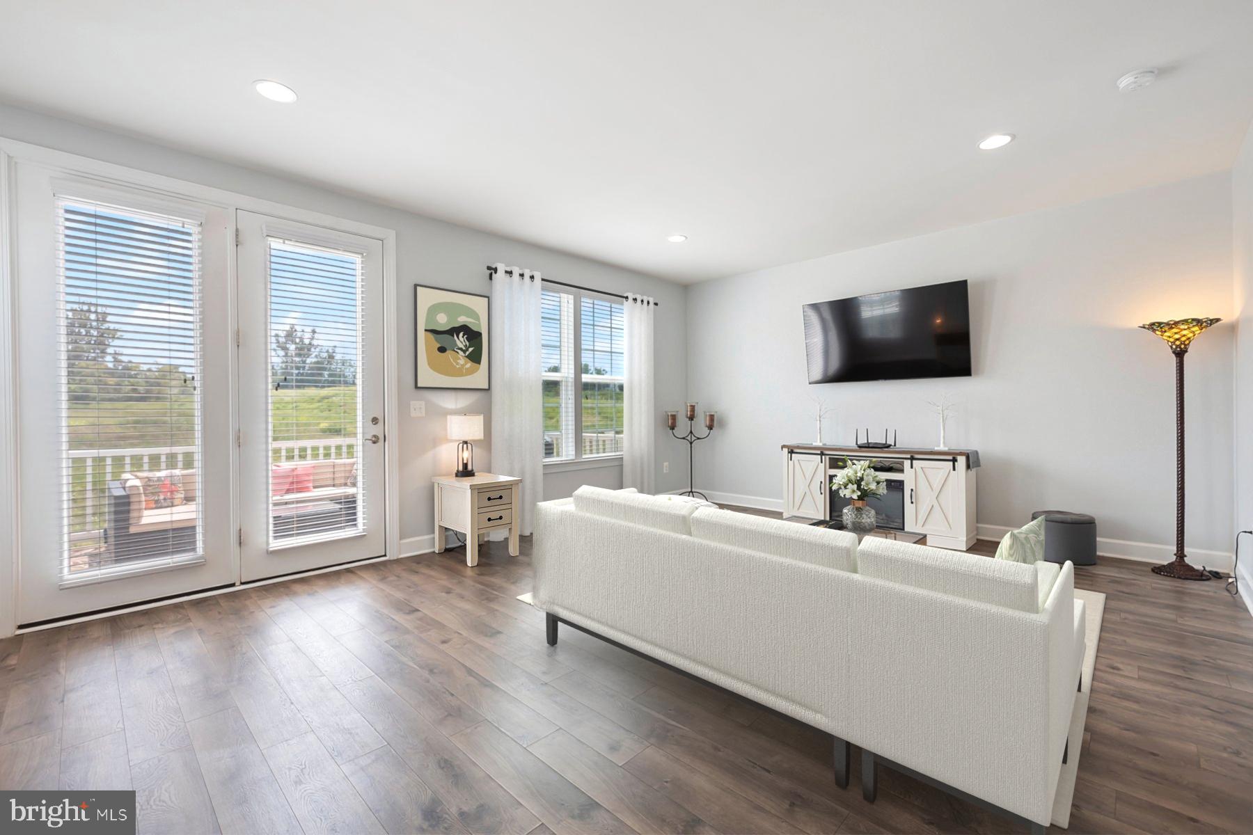 7071 Mongoose Trail Gainesville, VA 20155 - Photo 23 of 51 a living room with furniture and a flat screen tv