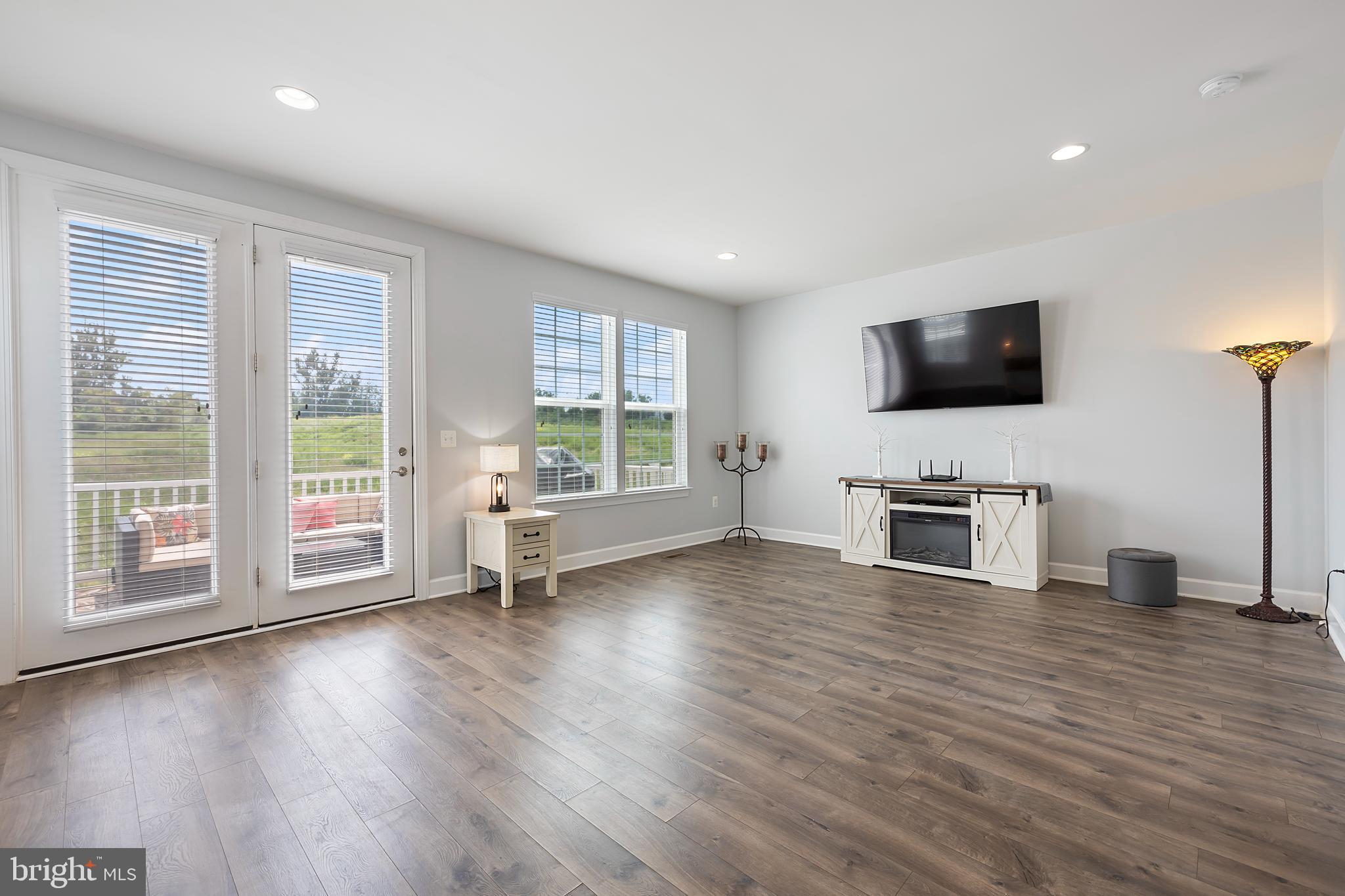 7071 Mongoose Trail Gainesville, VA 20155 - Photo 24 of 51 a view of a livingroom with hardwood floor and a flat screen tv