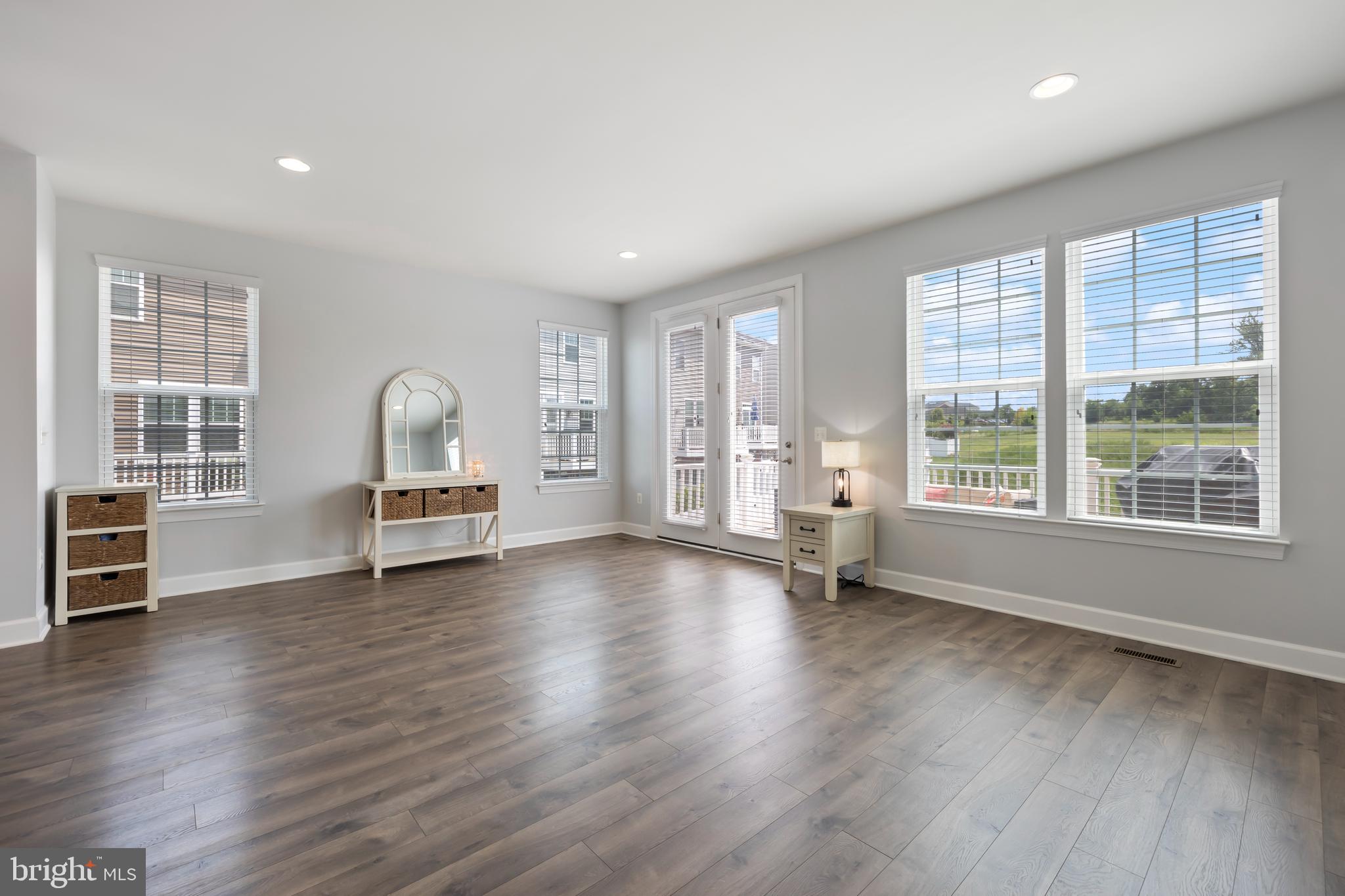 7071 Mongoose Trail Gainesville, VA 20155 - Photo 26 of 51 a view of empty room with wooden floor and floor to ceiling window