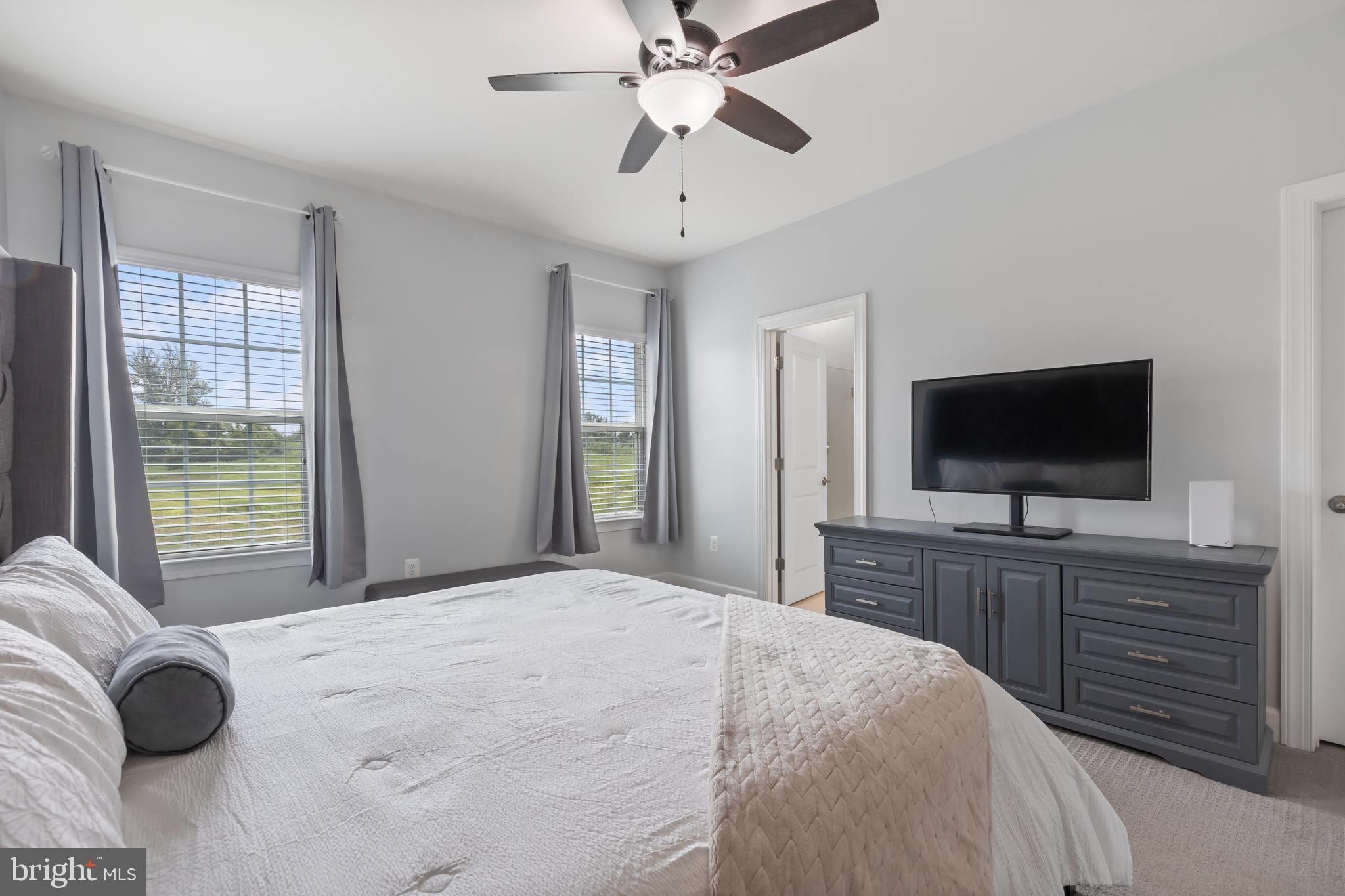 7071 Mongoose Trail Gainesville, VA 20155 - Photo 31 of 51 a bedroom with a bed and a flat screen television