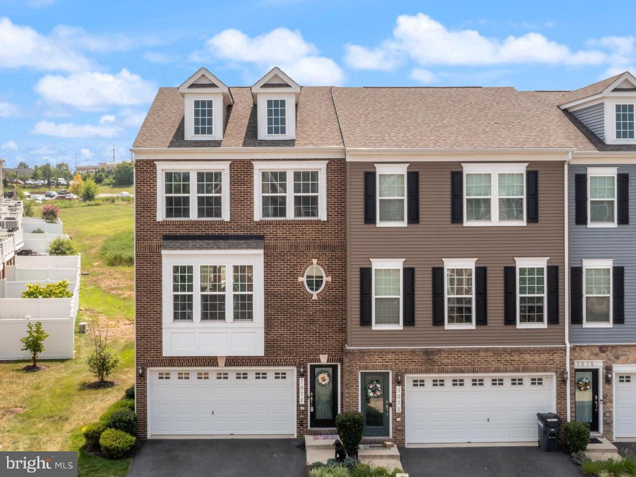 7071 Mongoose Trail Gainesville, VA 20155 - Photo 4 of 51 a front view of a building with glass windows
