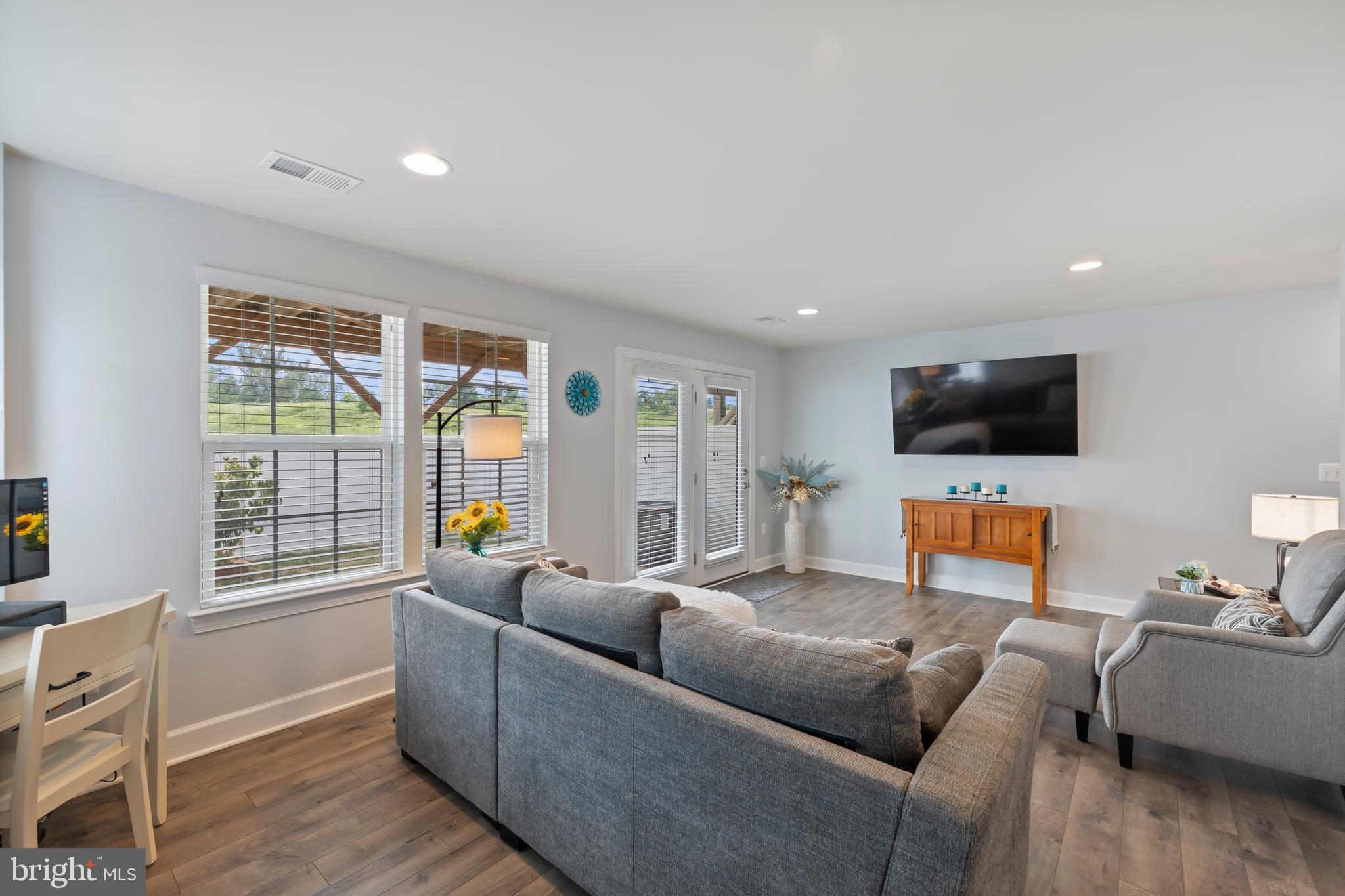 7071 Mongoose Trail Gainesville, VA 20155 - Photo 43 of 51 a living room with furniture a flat screen tv and a window