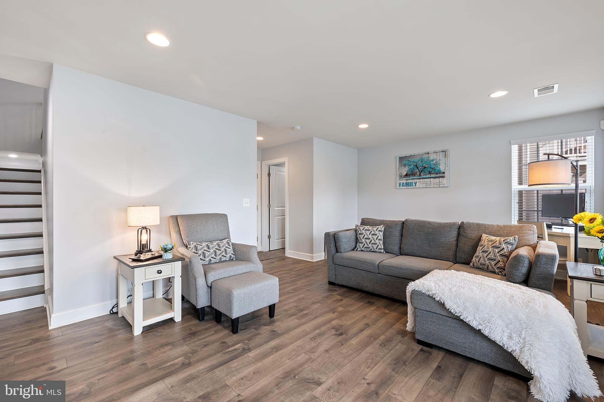 7071 Mongoose Trail Gainesville, VA 20155 - Photo 44 of 51 a living room with furniture and a wooden floor