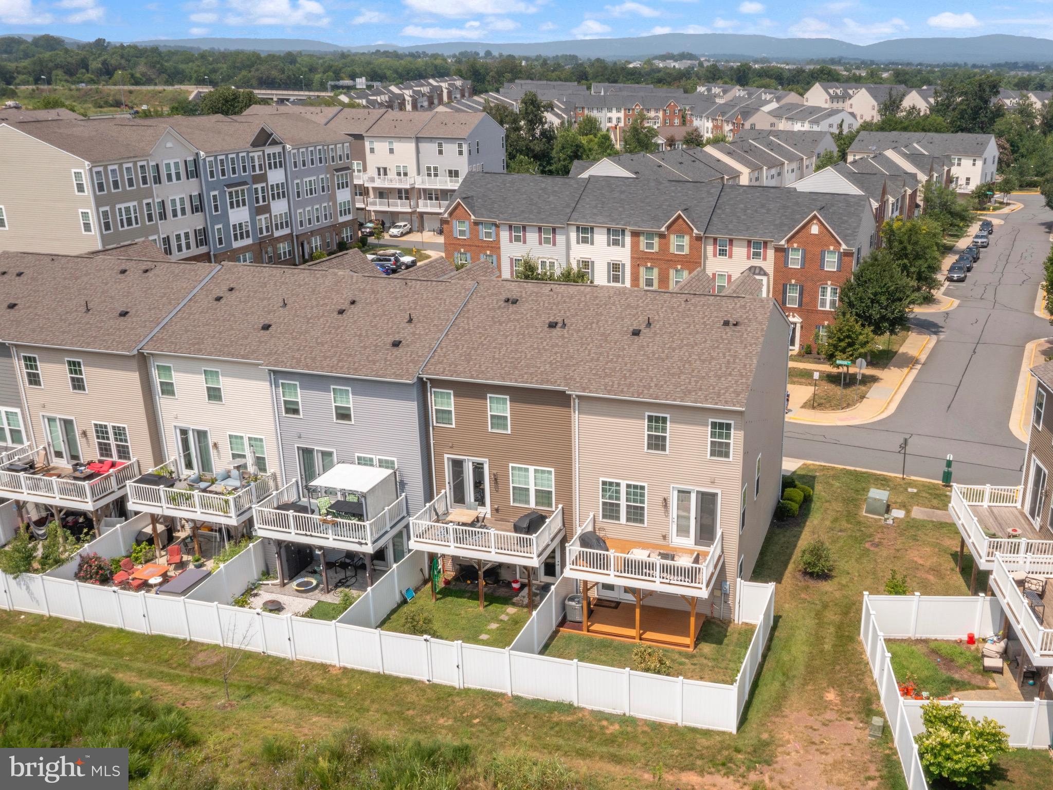 7071 Mongoose Trail Gainesville, VA 20155 - Photo 48 of 51 an aerial view of a house with a garden and lake view