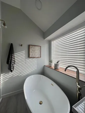 a bathroom with a toilet sink and mirror