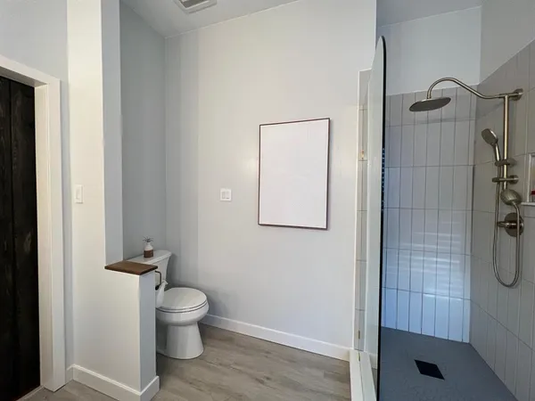 a bathroom with a toilet and a shower