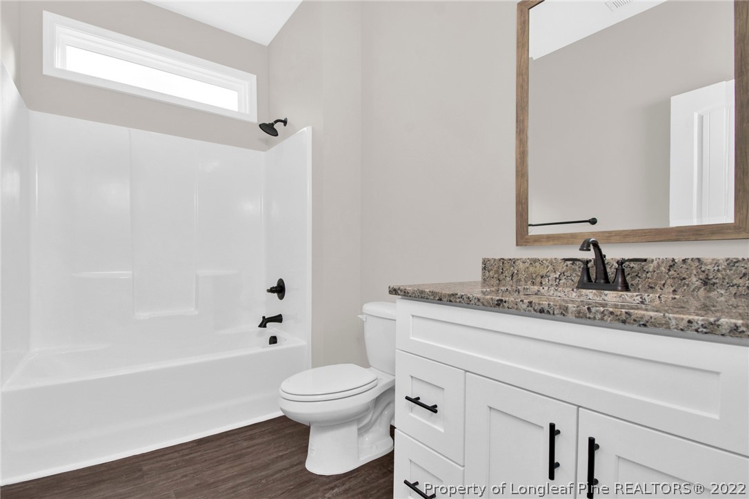 520 Pendergrass Road Raeford, NC 28376 - Photo 31 of 37 a bathroom with a granite countertop sink toilet and shower