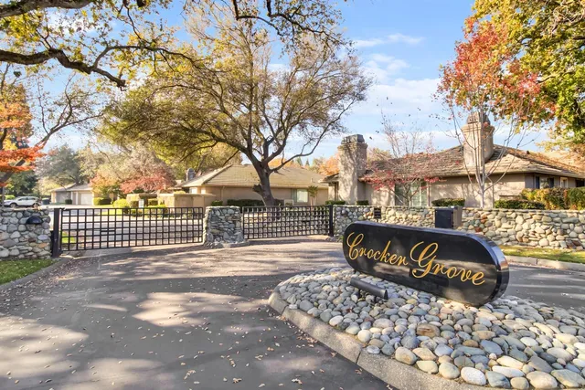 a view of a street with a bench and trees