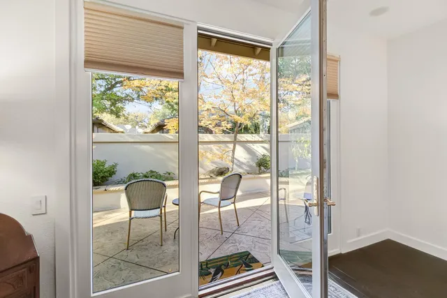 a living room with a floor to ceiling window and floor to ceiling window