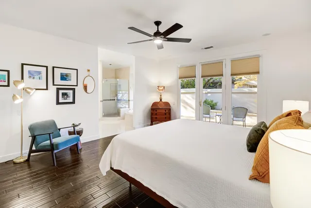 a bed room with a bed and a chair