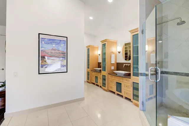 a large bathroom with a double vanity sink a mirror and a shower