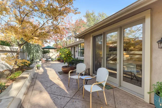a patio with yard glass top table and chairs