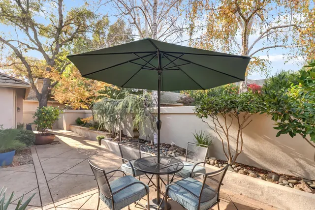 a view of a patio with furniture and a backyard