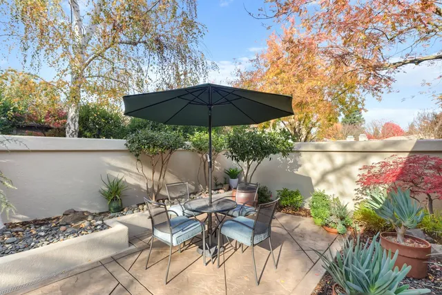 a view of backyard with outdoor seating and trees