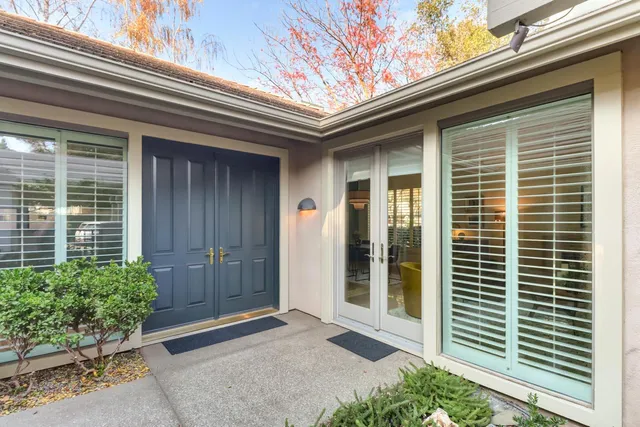 a front view of a house with plants