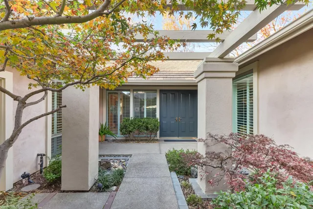a front view of a house with garden