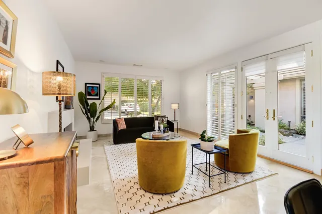 a living room with furniture a large window and a flat screen tv