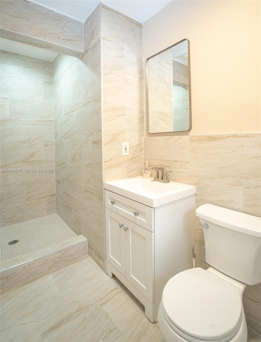 2230 Southwest 60th Court Miami, FL 33155 - Photo 32 of 35 a bathroom with a sink a toilet and shower