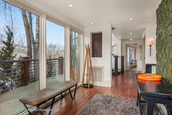 a living room with furniture a rug and a large window