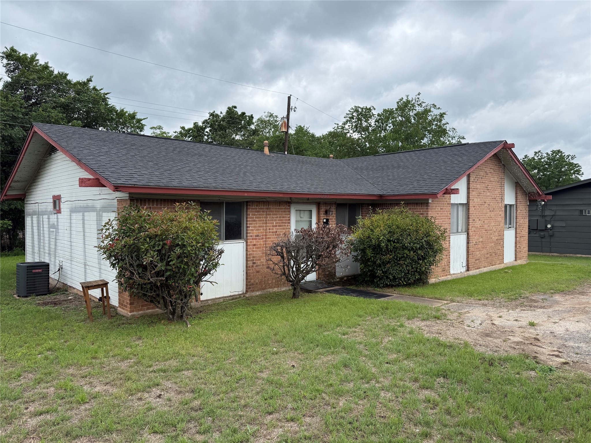a view of a house with garden and a yard