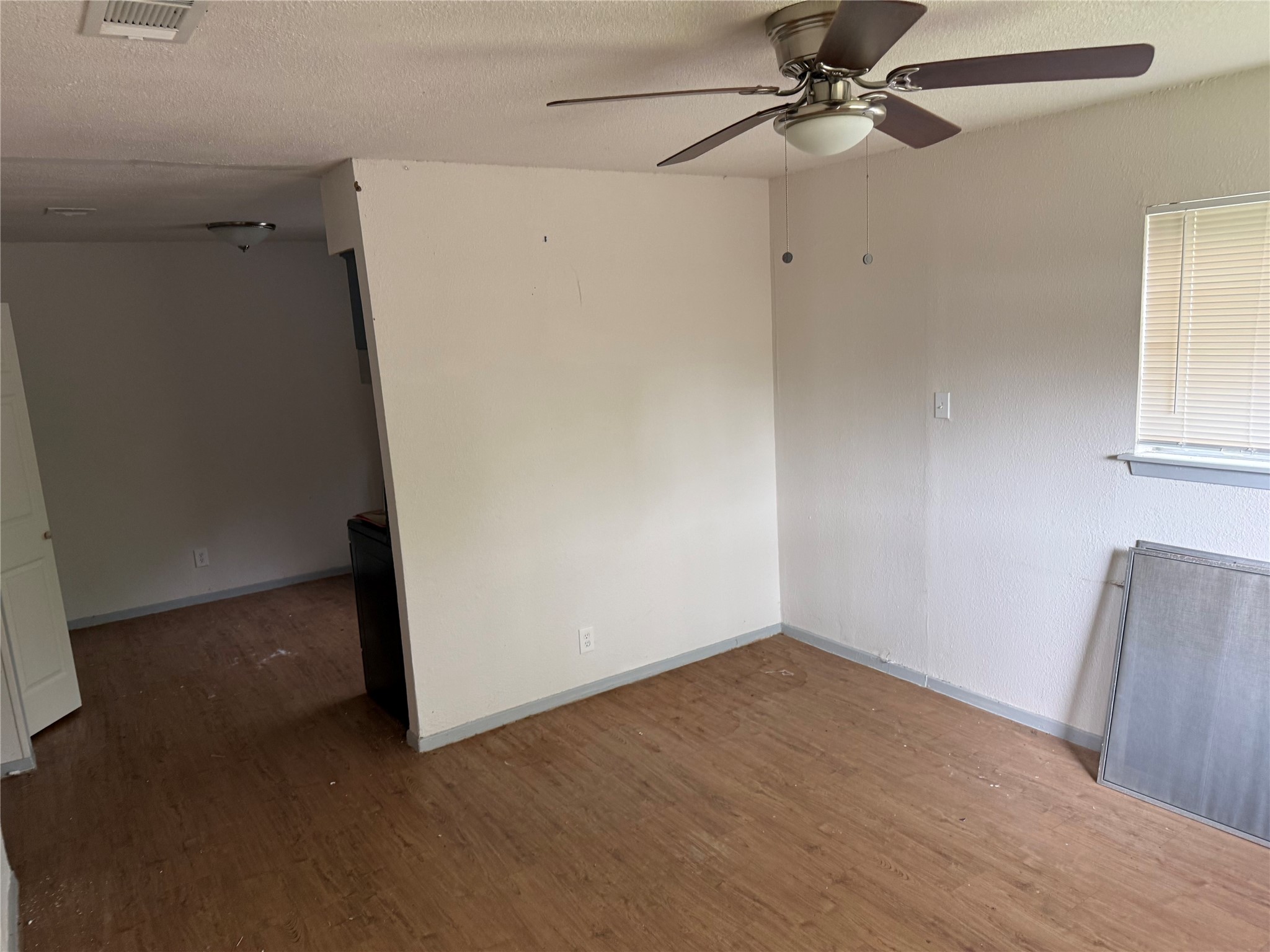 1303 Falcon Cove Austin, TX 78745 - Photo 12 of 16 a view of a room with wooden floor and fan
