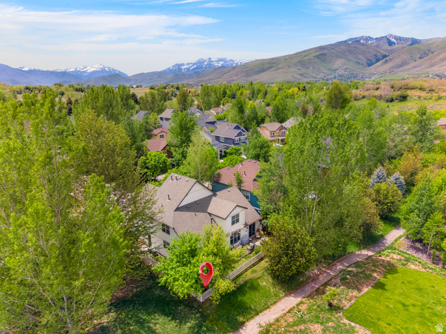 557 Craftsman Way Midway, UT 84049 - Photo 56 of 59 Aerial perspective showcasing a residential property with a brown shingle roof amidst abundant mature trees