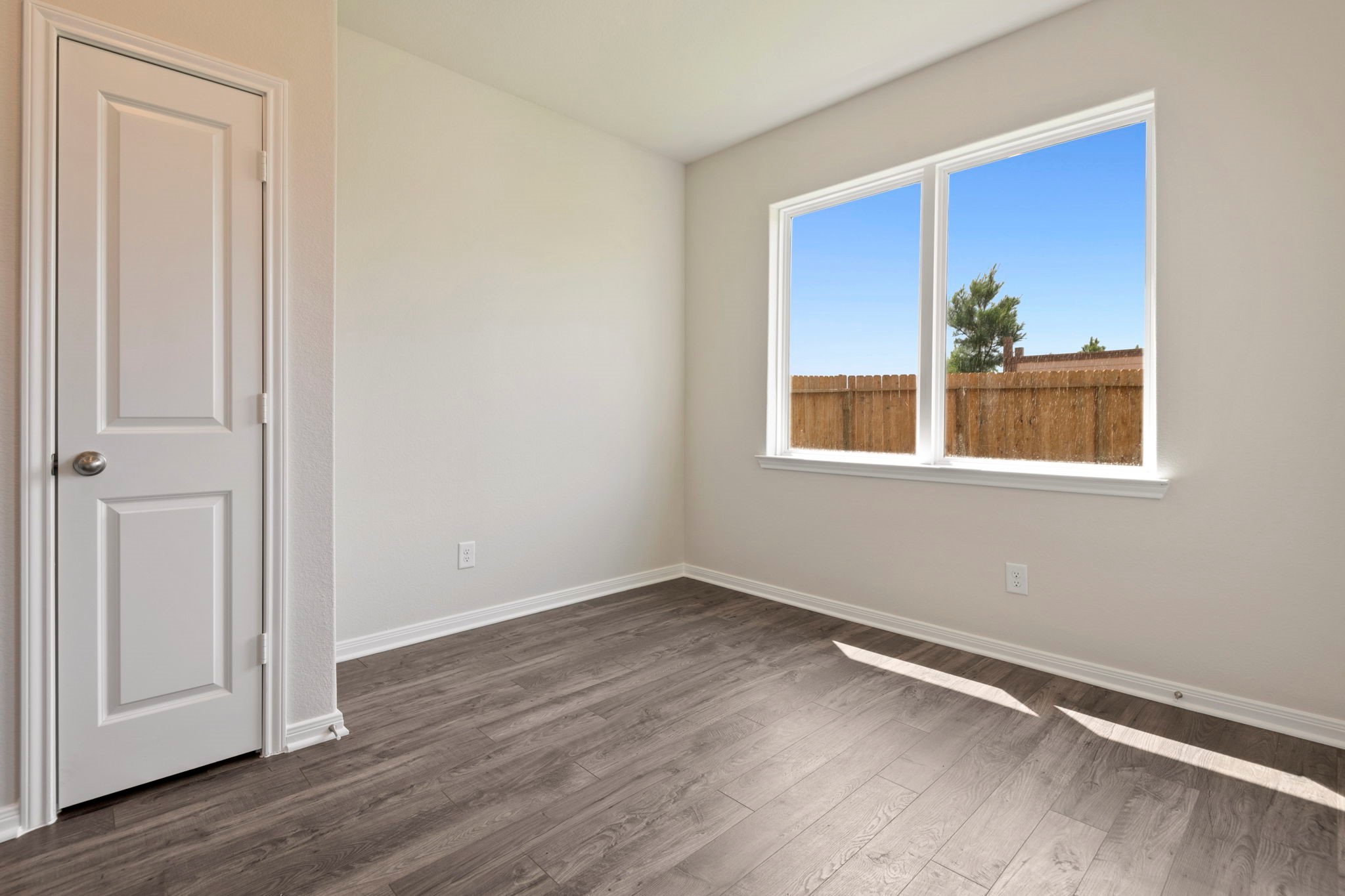 10351 Red Cardinal Drive Cleveland, TX 77328 - Photo 15 of 25 a view of an empty room with wooden floor and a window