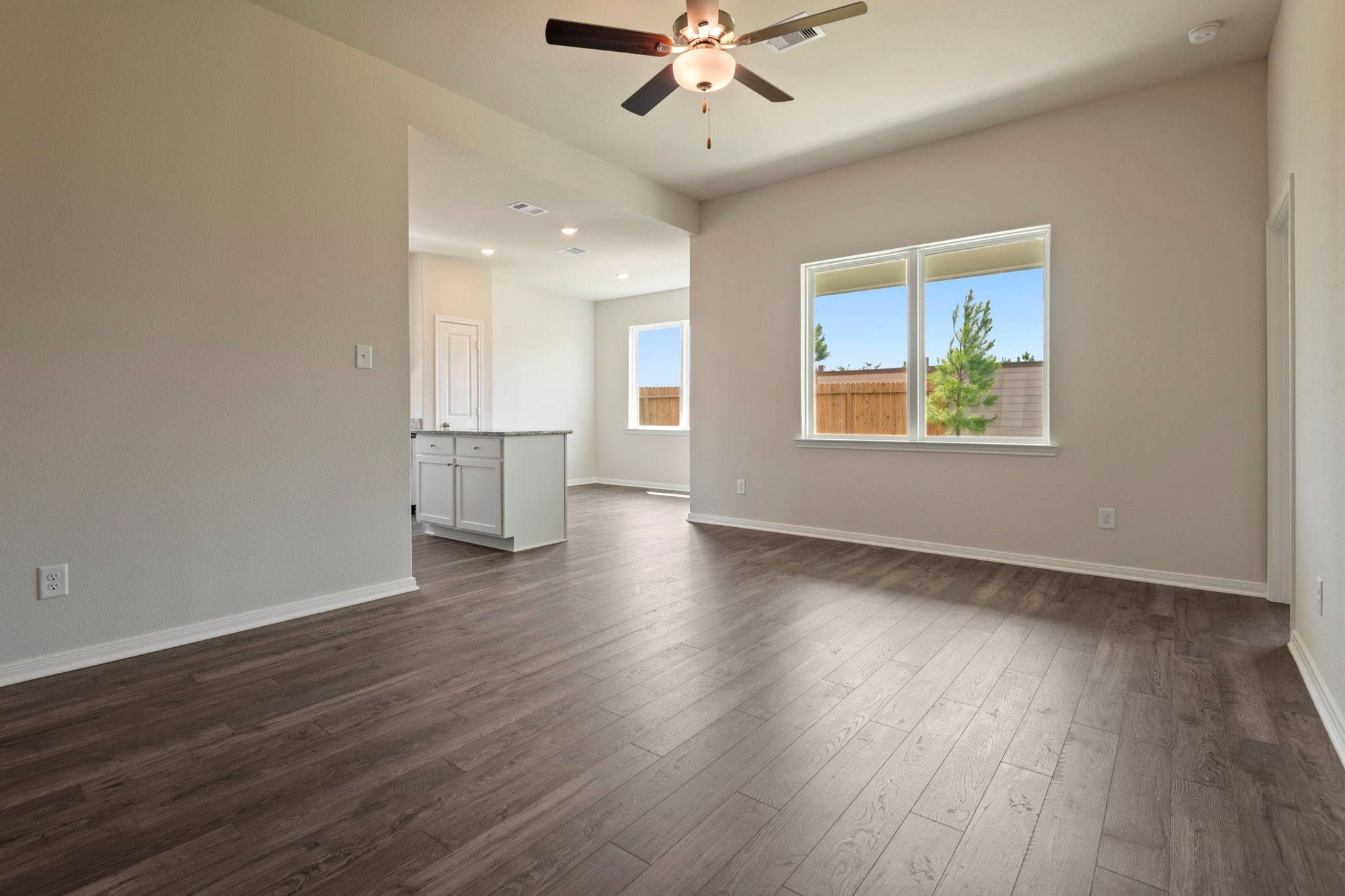 10351 Red Cardinal Drive Cleveland, TX 77328 - Photo 3 of 25 a view of an empty room with wooden floor and a window