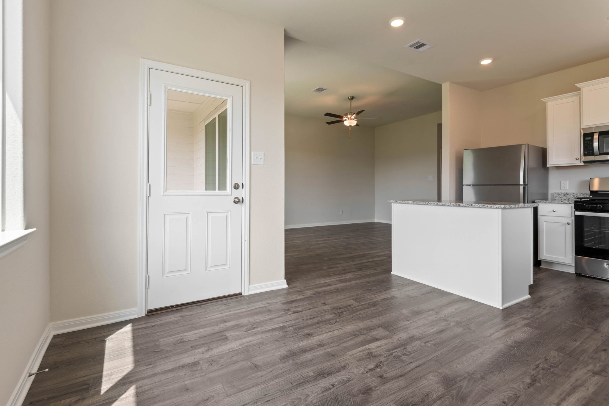10351 Red Cardinal Drive Cleveland, TX 77328 - Photo 5 of 25 a view of a kitchen with a sink and a refrigerator