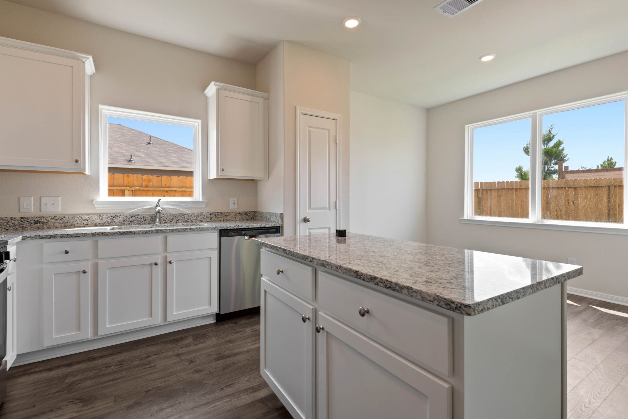 10351 Red Cardinal Drive Cleveland, TX 77328 - Photo 10 of 25 a kitchen with granite countertop cabinets stainless steel appliances a sink and a window